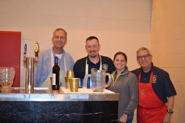 Group standing in front of drinks bar